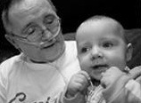 Larry Hill, on oxygen, holding a baby